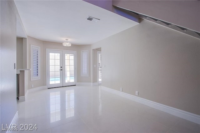 interior space with light tile patterned flooring and french doors