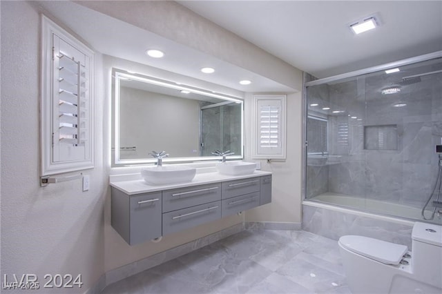 full bathroom featuring vanity, enclosed tub / shower combo, and toilet