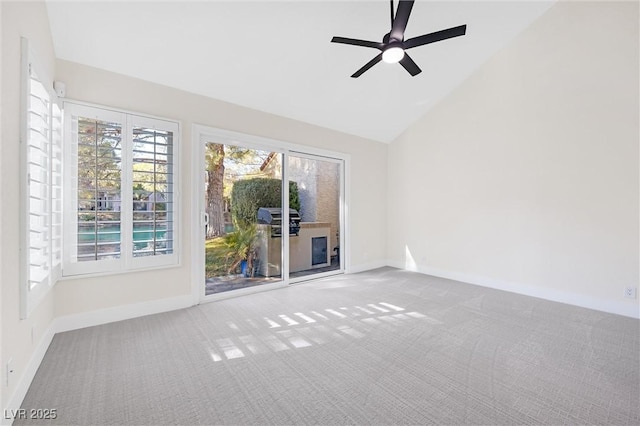 unfurnished room featuring ceiling fan, vaulted ceiling, and carpet