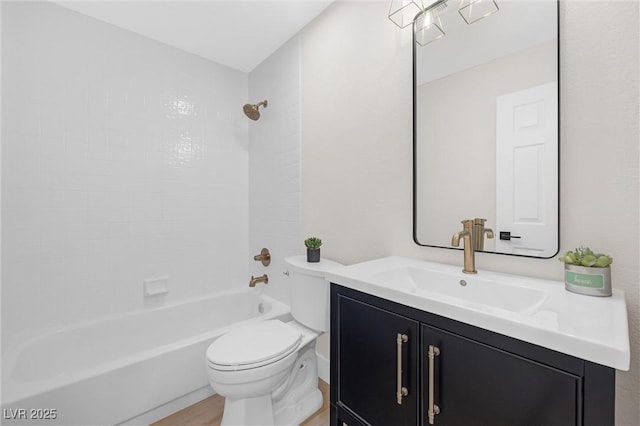 full bathroom featuring tiled shower / bath combo, vanity, hardwood / wood-style flooring, and toilet