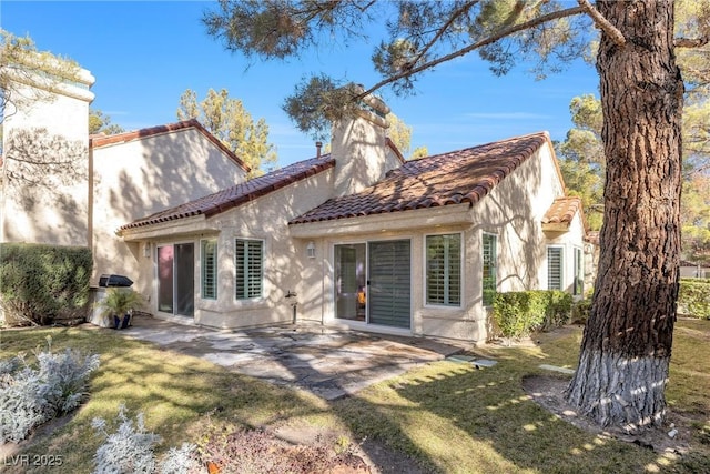 back of property featuring a yard and a patio area