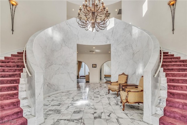 entryway featuring a chandelier and a high ceiling