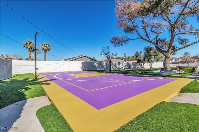 view of sport court with a yard