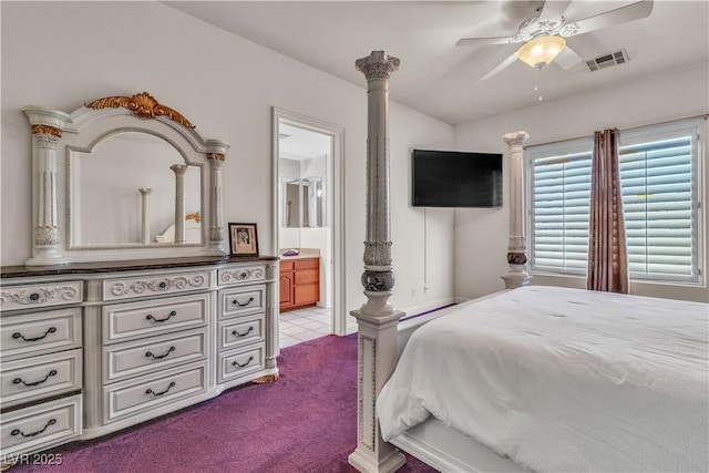 bedroom featuring ceiling fan, light colored carpet, and ensuite bathroom