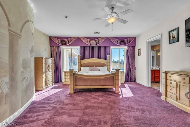 bedroom with ceiling fan, multiple windows, ensuite bathroom, and carpet