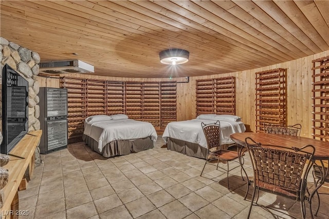 tiled bedroom featuring a wall unit AC and wooden ceiling