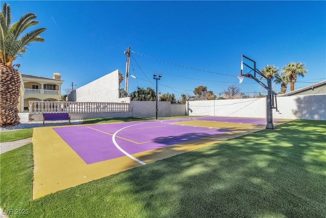 view of basketball court with a lawn