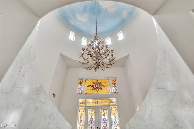 details with an inviting chandelier and french doors