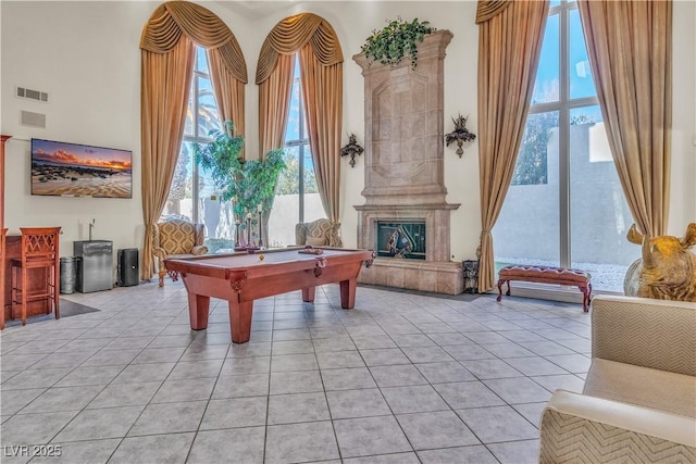 game room featuring light tile patterned floors, pool table, and a high ceiling