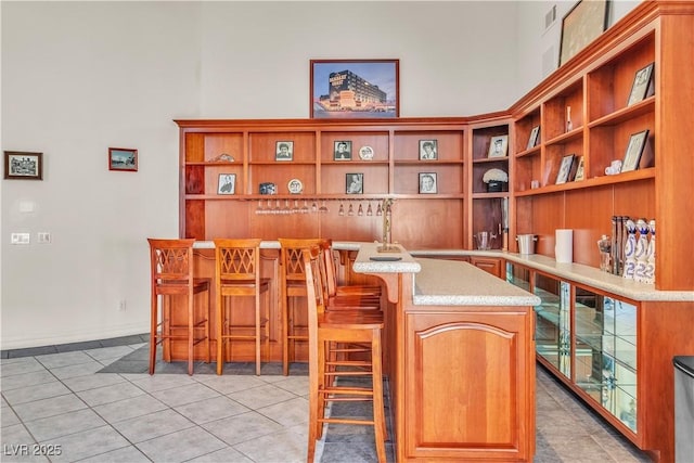 interior space with bar and light tile patterned floors