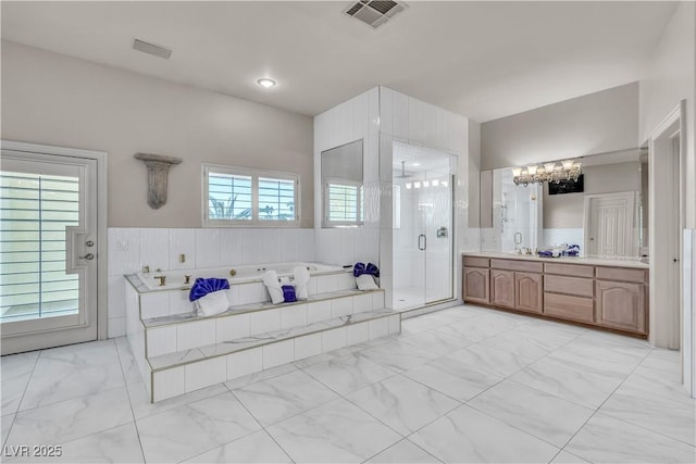 bathroom featuring vanity, plus walk in shower, and a chandelier