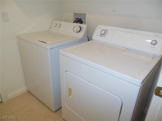 washroom featuring separate washer and dryer and light tile patterned floors