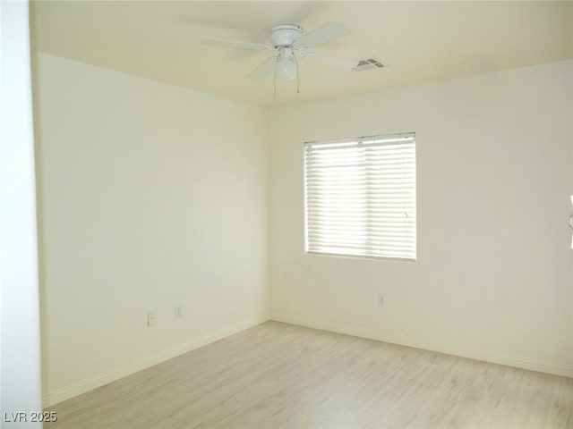 spare room featuring ceiling fan and light hardwood / wood-style floors