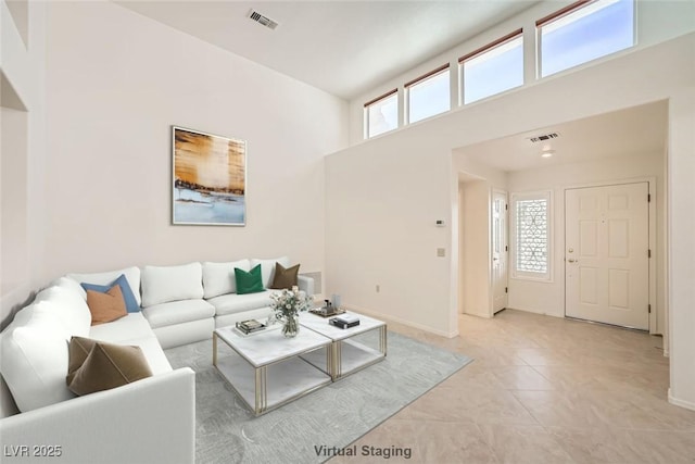 tiled living room with a high ceiling