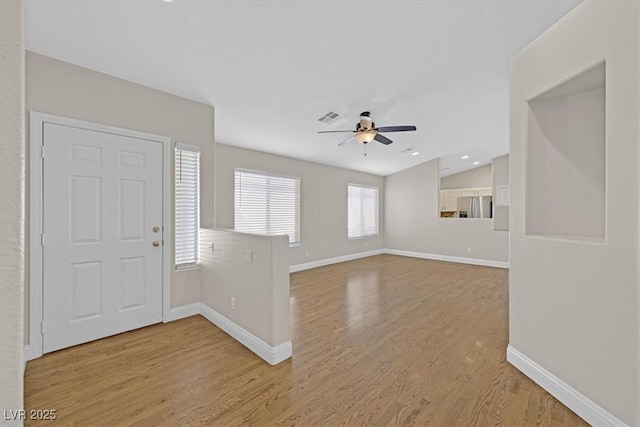 entryway with wood-type flooring, ceiling fan, and vaulted ceiling