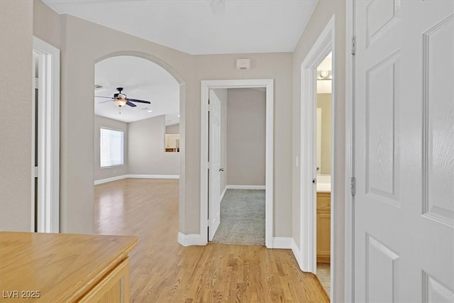 corridor with light hardwood / wood-style flooring