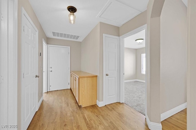 hallway with light hardwood / wood-style flooring