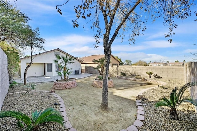 view of yard with a garage and a patio