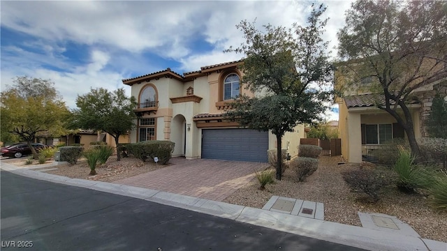 mediterranean / spanish-style house with a garage