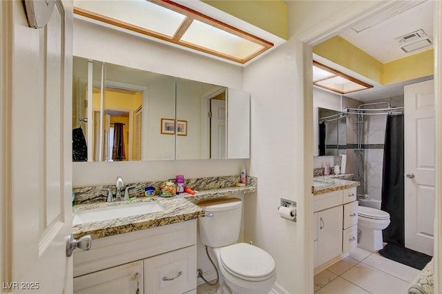 full bathroom with vanity, toilet, tile patterned flooring, and shower / bath combo with shower curtain