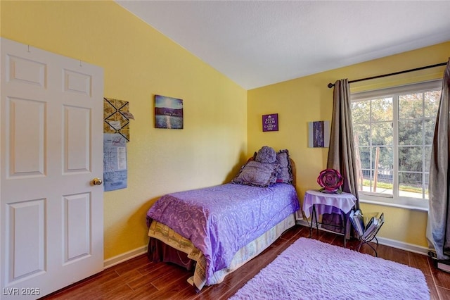 bedroom featuring dark hardwood / wood-style flooring and vaulted ceiling