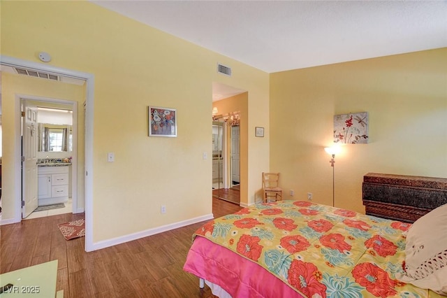 bedroom with sink and hardwood / wood-style flooring