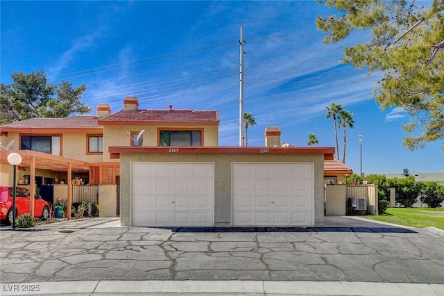 view of front of house with a garage and cooling unit