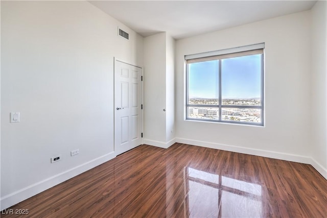 empty room with dark hardwood / wood-style floors