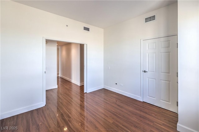 unfurnished bedroom featuring dark hardwood / wood-style flooring