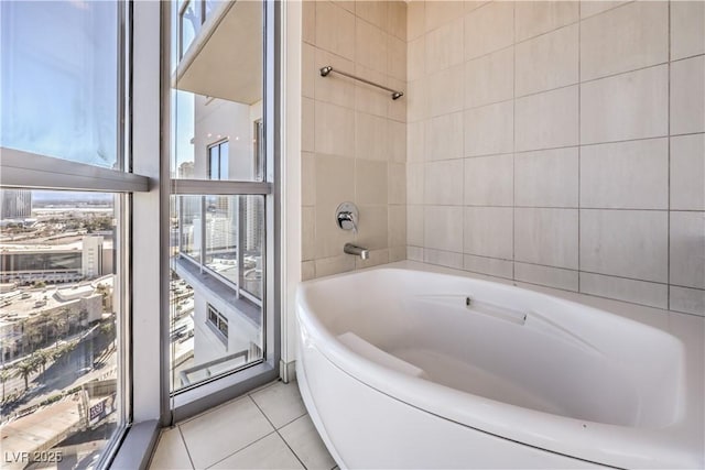 bathroom with tile patterned floors and a bathing tub