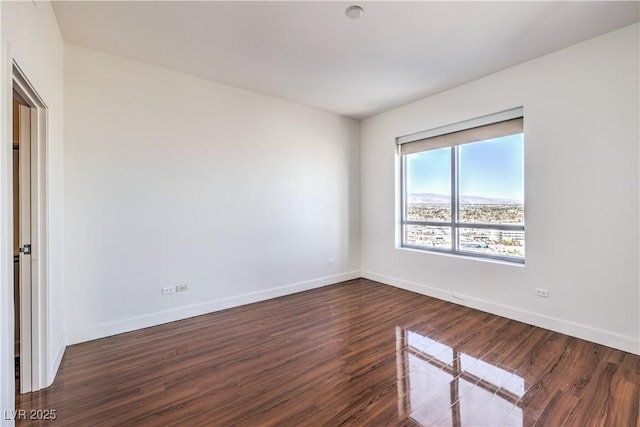 empty room with dark wood-type flooring