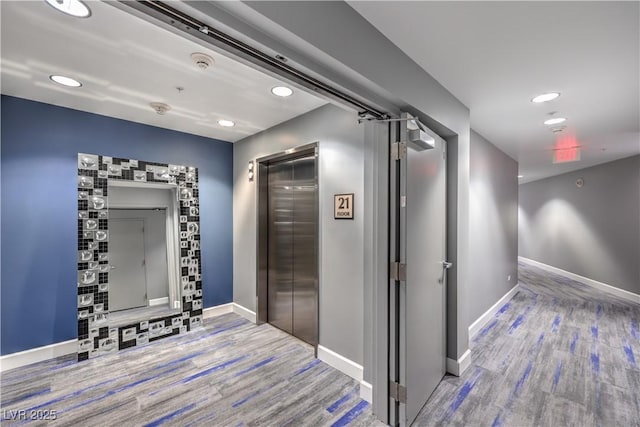 hall featuring hardwood / wood-style floors and elevator