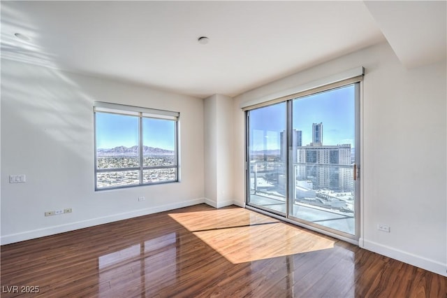 empty room with dark hardwood / wood-style floors
