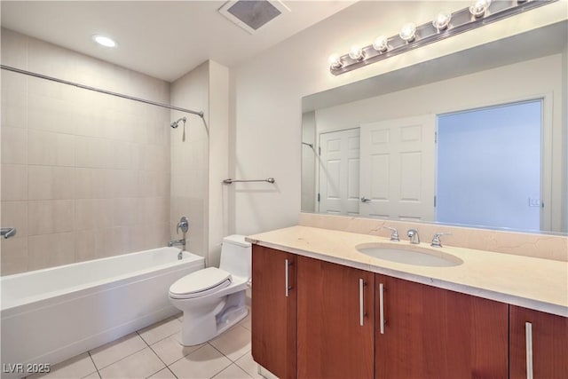 full bathroom with tiled shower / bath, tile patterned floors, toilet, and vanity
