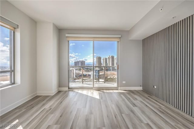 200 W Sahara Ave Unit 2108, Las Vegas, NV 89102 - spare room with wood finished floors, a view of city, and baseboards