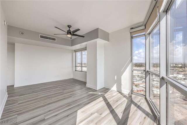 200 W Sahara Ave Unit 2108, Las Vegas, NV 89102 - unfurnished room with light wood finished floors, a ceiling fan, and baseboards