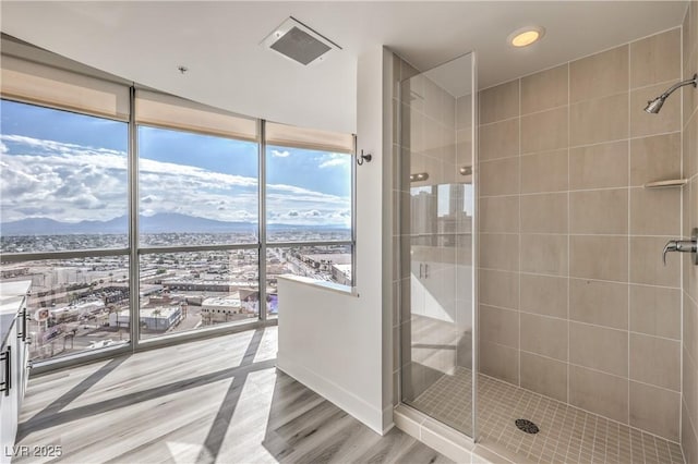 200 W Sahara Ave Unit 2108, Las Vegas, NV 89102 - full bath with a stall shower, a mountain view, wood finished floors, a wall of windows, and vanity