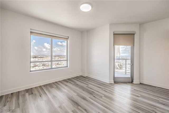 200 W Sahara Ave Unit 2108, Las Vegas, NV 89102 - spare room with healthy amount of natural light, light wood-type flooring, and baseboards