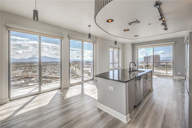 200 W Sahara Ave Unit 2108, Las Vegas, NV 89102 - kitchen featuring healthy amount of natural light, dark countertops, a sink, light wood-type flooring, and recessed lighting