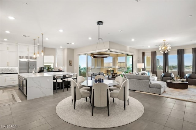 tiled dining room featuring plenty of natural light and sink