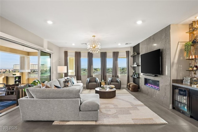 living room featuring a notable chandelier, indoor bar, beverage cooler, and a fireplace