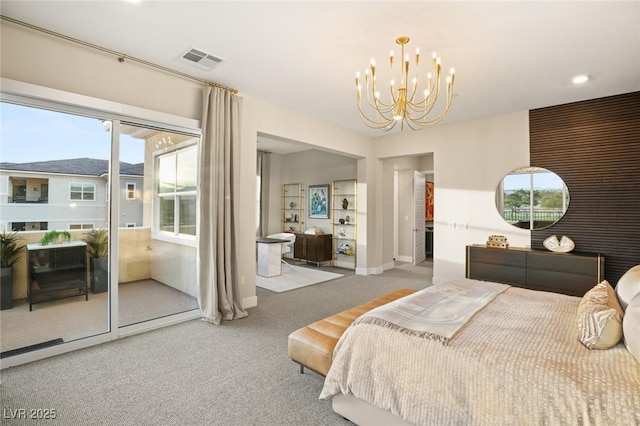 carpeted bedroom featuring an inviting chandelier