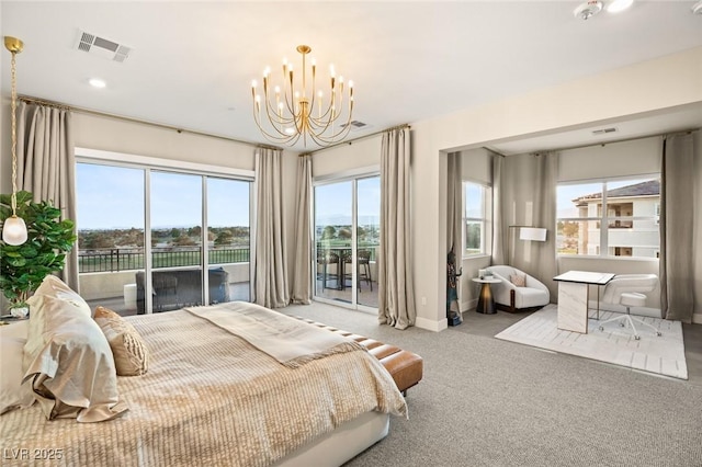 carpeted bedroom with access to exterior and a notable chandelier