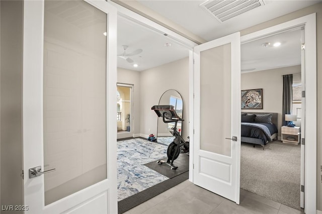 exercise area with french doors, light colored carpet, plenty of natural light, and ceiling fan