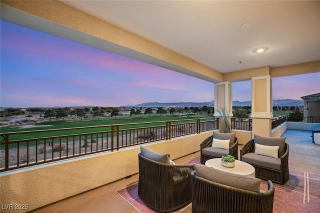 patio terrace at dusk with a balcony and a mountain view