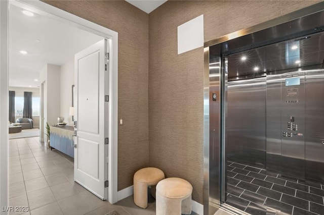 bathroom with elevator and tile patterned floors