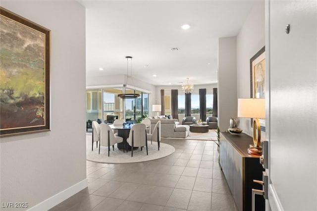 interior space with light tile patterned floors and an inviting chandelier