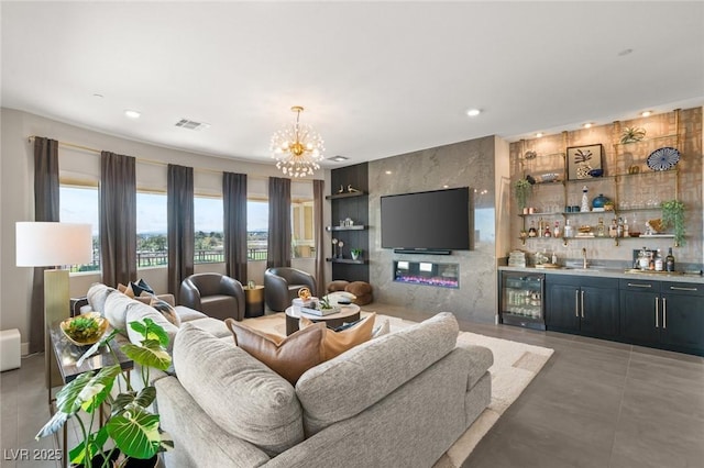 living room with indoor bar, tile walls, wine cooler, a chandelier, and tile patterned flooring