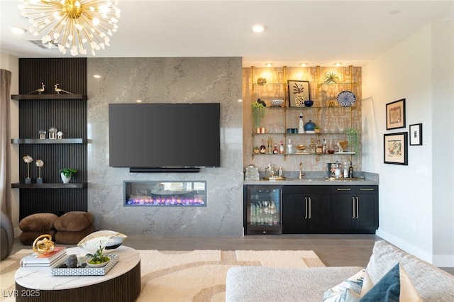 bar featuring sink, light tile patterned floors, beverage cooler, a notable chandelier, and a fireplace