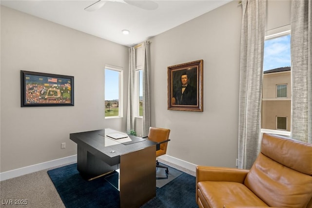 home office with ceiling fan and dark carpet